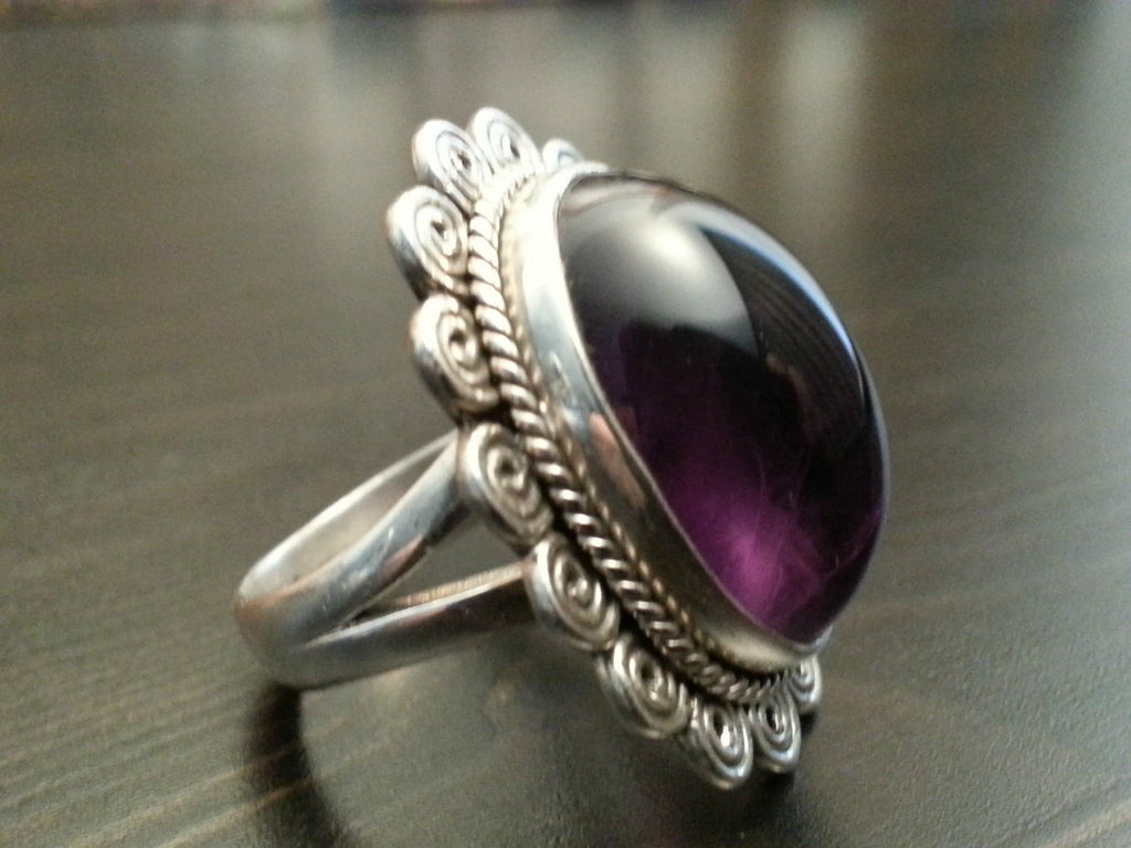 Stylish sterling silver ring with purple amethyst cabochon