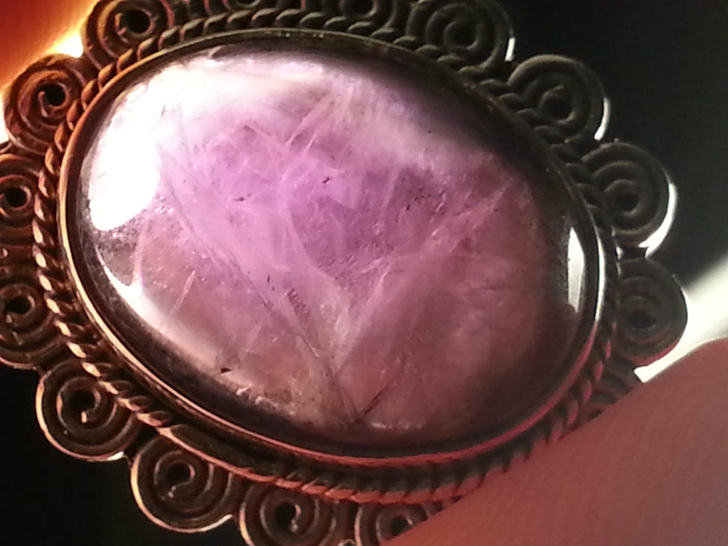 Stylish sterling silver ring with purple amethyst cabochon
