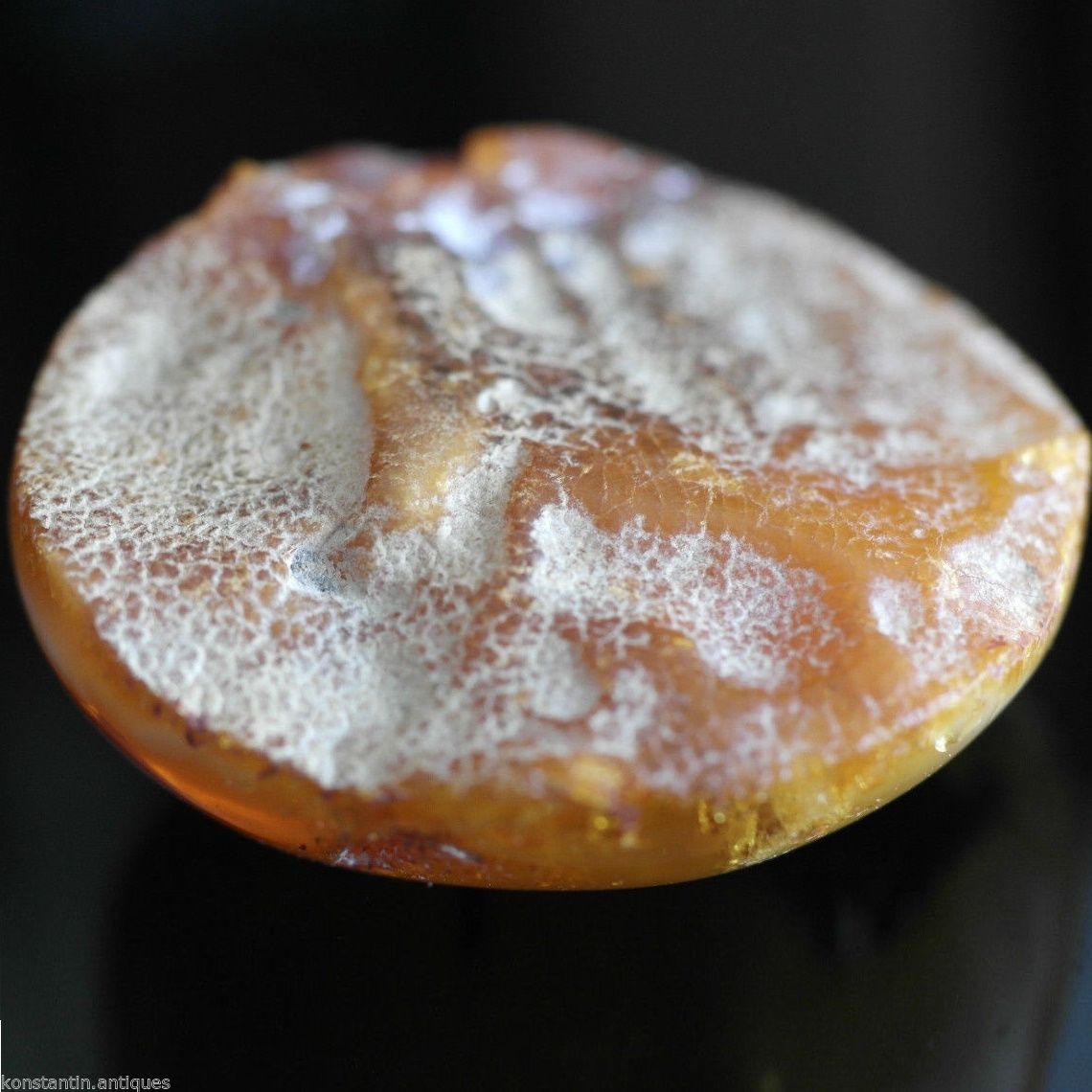 Genuine Baltic Amber polished raw stone in the display frame