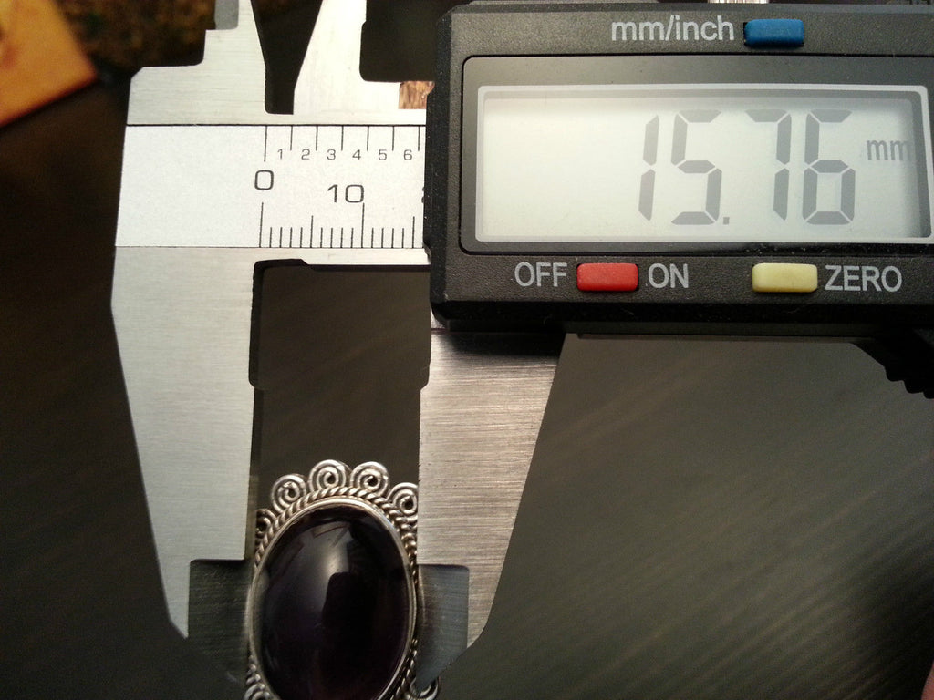 Stylish sterling silver ring with purple amethyst cabochon