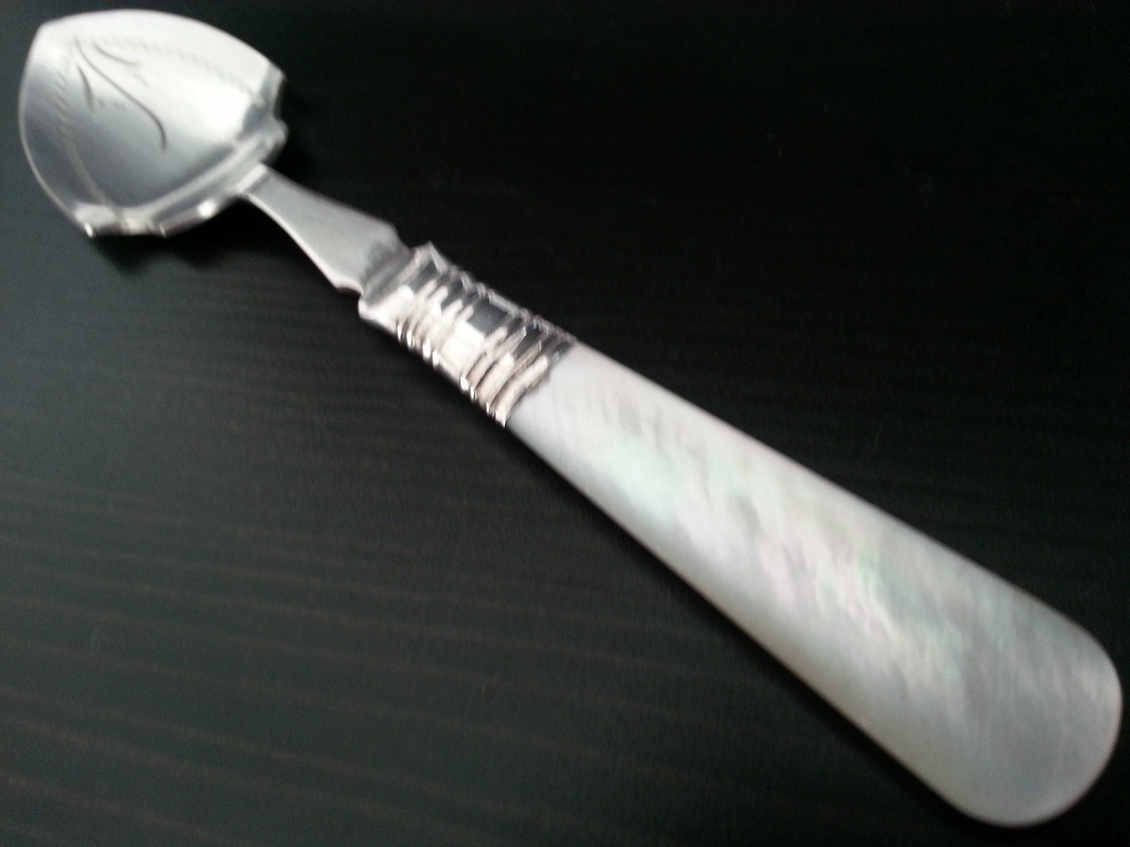 Antique silver plated dessert spoon ornamented with mother of pearl handle British Empire