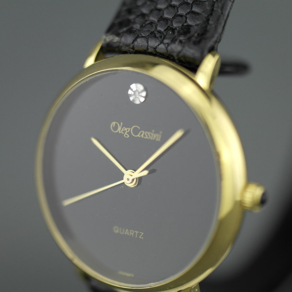 Elegant Oleg Cassini diamond gold plated case ladies wrist watch with black dial