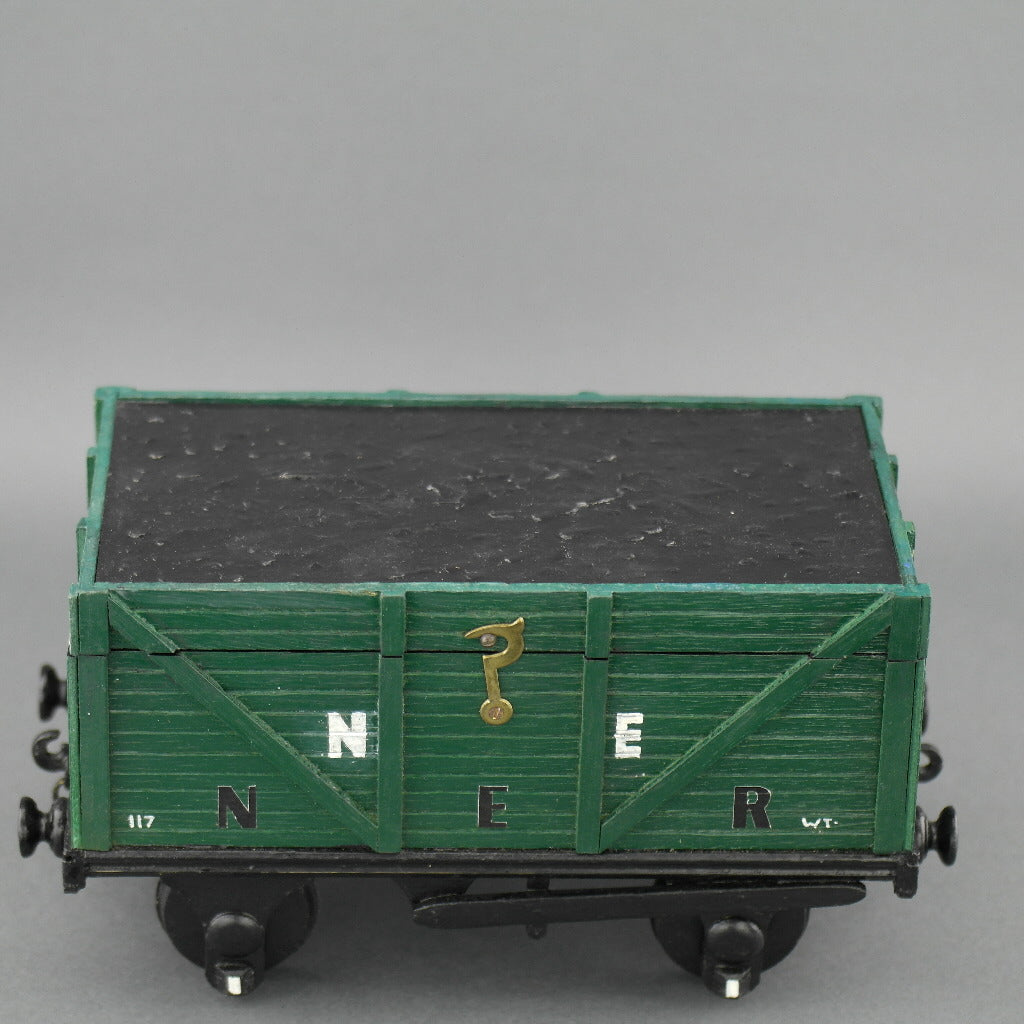 Vintage secret wooden box in shape of a train wagon full of coal