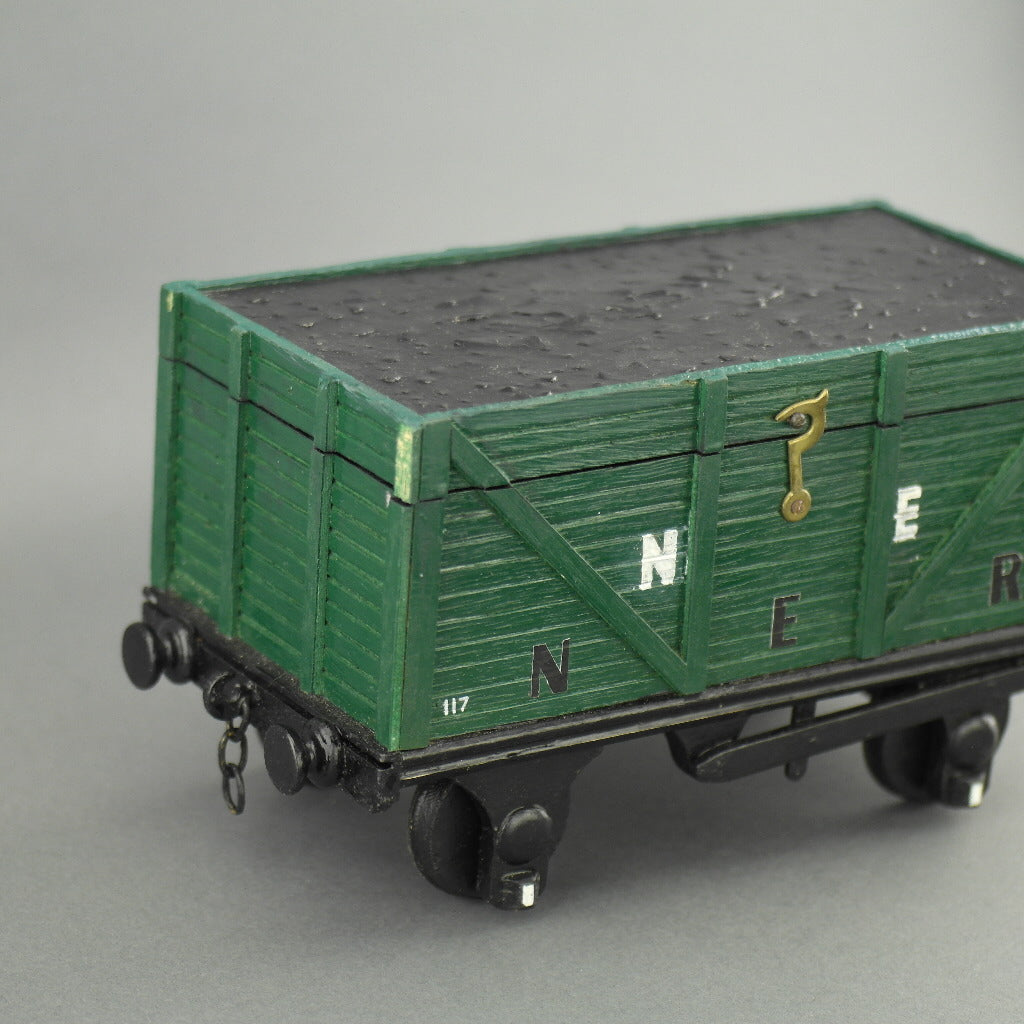 Vintage secret wooden box in shape of a train wagon full of coal