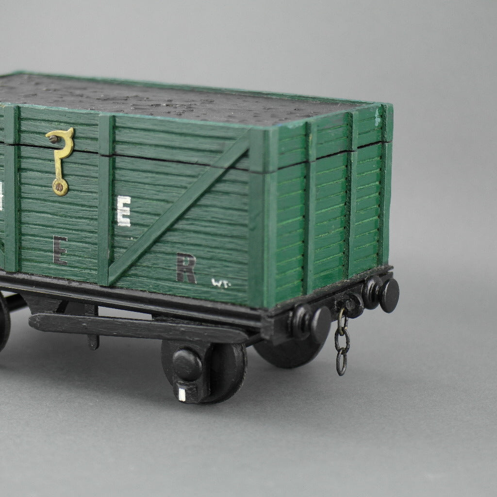 Vintage secret wooden box in shape of a train wagon full of coal