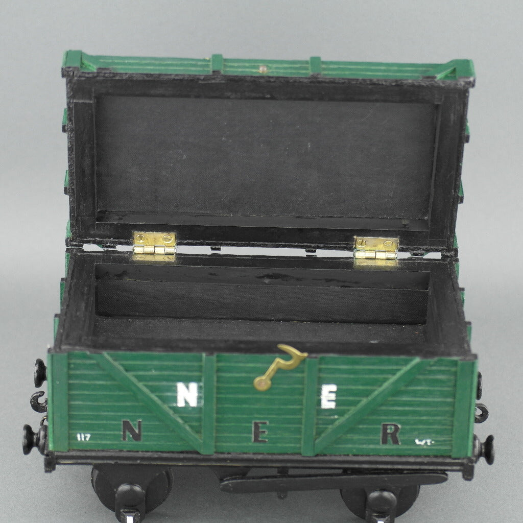 Vintage secret wooden box in shape of a train wagon full of coal