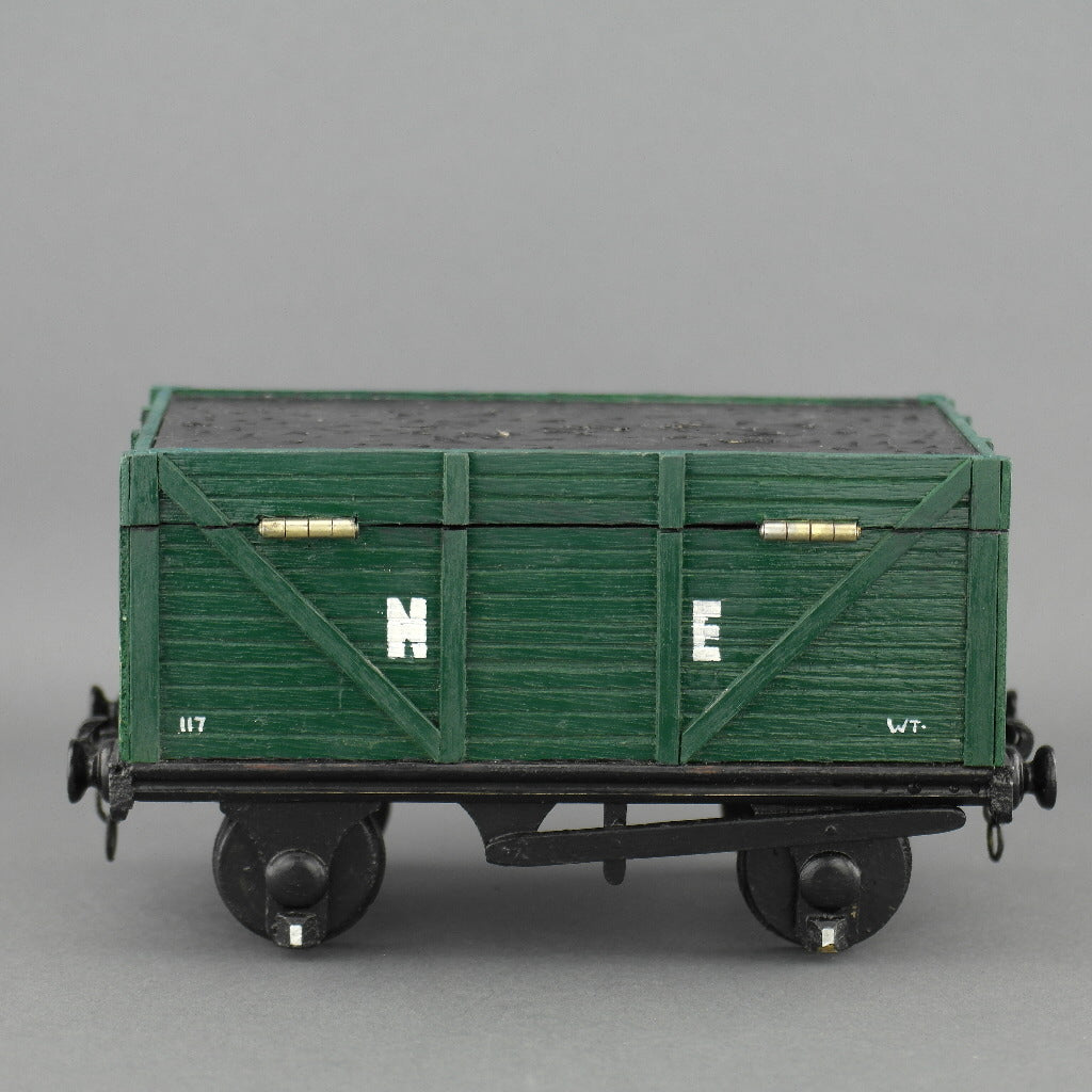 Vintage secret wooden box in shape of a train wagon full of coal