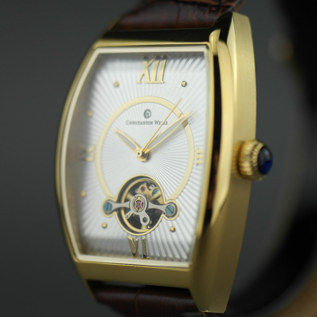 Reloj mecánico Constantin Weisz chapado en oro con correa de piel marrón.
