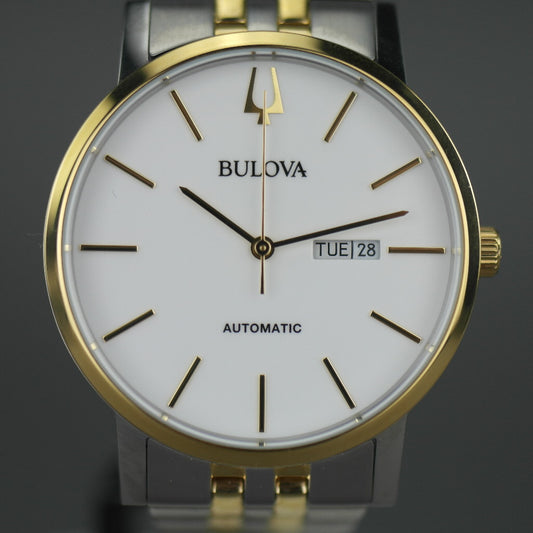 Reloj automático Bulova para hombre con esfera blanca y fecha bilingüe con pulsera de acero inoxidable y elementos chapados en oro