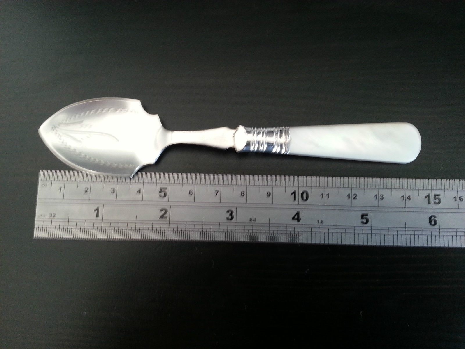 Antique silver plated dessert spoon ornamented with mother of pearl handle British Empire